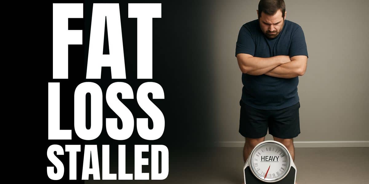 Overweight man looking down at a bathroom scale with the needle bent at heavy, symbolizing why weight loss slows down when progress stalls.