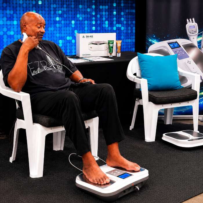 Guest experiencing the OlyLife TERA P90 Plus with handheld attachment at Twelftree Wellness Centre